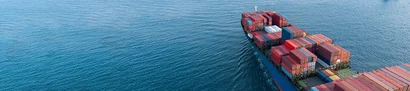 Container ship with colourful freight containers on the open sea as a symbol of technical trade.