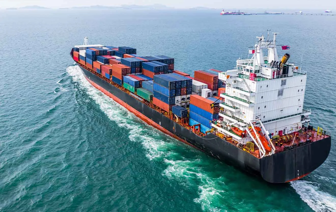 Container ship with colourful freight containers on the open sea