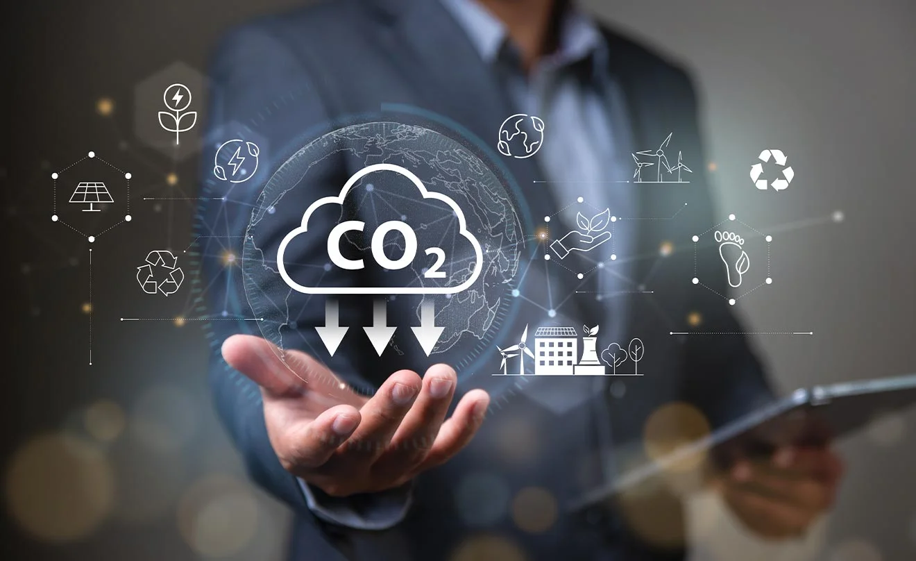 Grüne Technologien aus der Cloud reduzieren den CO2-Fußabdruck Cloud-Wolke mit Schriftzug CO2 und sinkenden Pfeilen schwebt über Hand