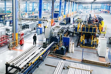 Transparente Produktionsabläufe – gesteuert mit unitop Industriehalle mit Maschinen, Förderstrecken und laufender Produktion in mittlerer Perspektive.