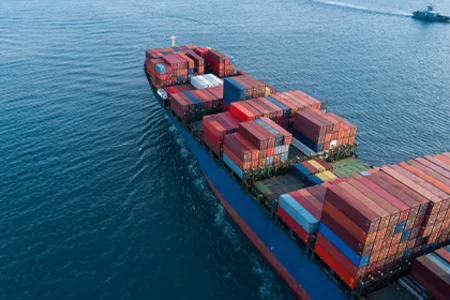 Container ship with colourful freight containers on the open sea as a symbol of technical trade.