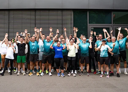 GOB RUN & FUN 2026 mit voller Energie as GOB-Laufteam posiert beim internen Firmenlauf GOB RUN & FUN 2026 mit erhobenen Armen.