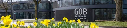 GOB-Firmengebäude in Krefeld im Frühling mit blühenden Narzissen im Vordergrund