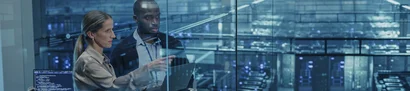 Identifying potential, developing solutions – with our AI consultancy Iconic image: Two people with laptop doing an AI consultation in front of server racks behind glass